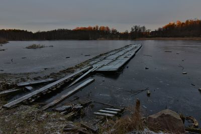 Scenic view of lake against sky during winter