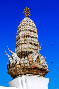 Low angle view of statue against blue sky