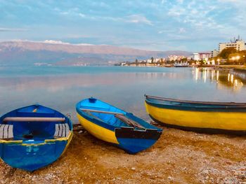 Boats moored on sea against sky