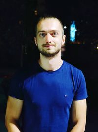 Portrait of young man standing at night