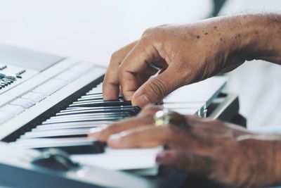 Cropped image of man playing piano