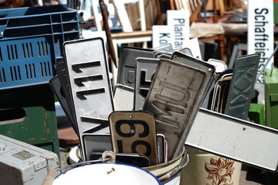 Close-up of license plates in bucket