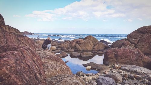 Panoramic view of rocks on beach against sky