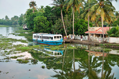 Boat in canal by trees