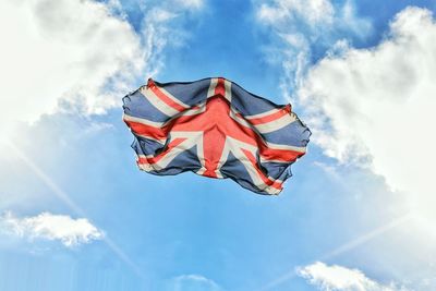 Low angle view of flag against blue sky