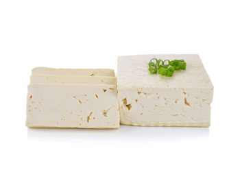 Close-up of bread in plate against white background