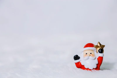 Stuffed toy on snow during winter