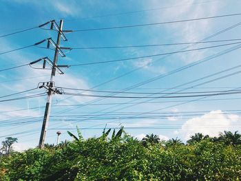 Low angle view of electricity pylon against sky