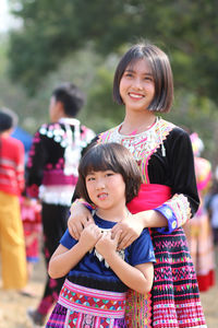 Portrait of smiling girl standing outdoors