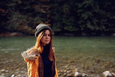 Portrait of young woman standing in water