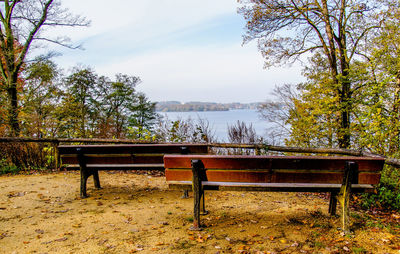 Empty bench in park during autumn