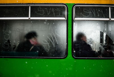 View of commuters through train window