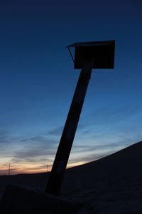 Low angle view of silhouette cross against sky during sunset