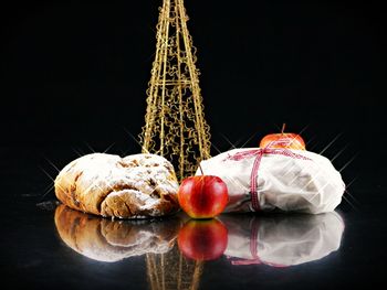 Close-up of christmas decoration on table against black background