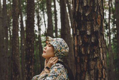 Side view of woman in forest