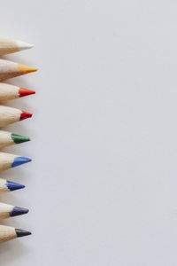 Rainbow of coloring pencil tips on plain white background