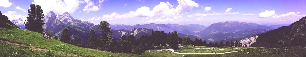 Scenic view of mountains against cloudy sky