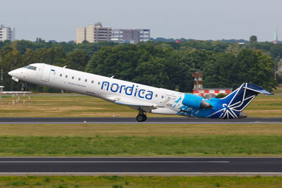 View of airplane on airport runway against sky