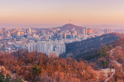 Aerial view of cityscape against sky during autumn