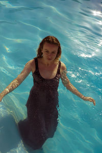 High angle view of young woman in swimming pool