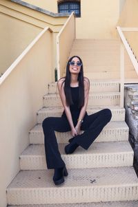 Portrait of young woman sitting on staircase