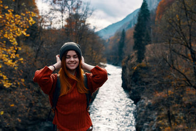 Young woman standing in park during autumn