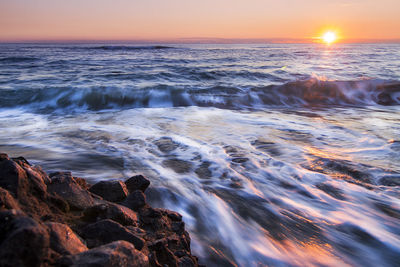 Scenic view of sea at sunset