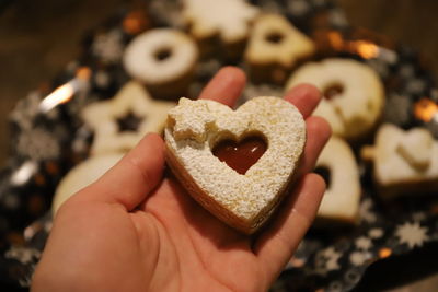 Cropped hand of person holding cookies