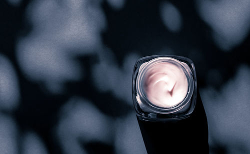 Midsection of woman holding light bulb