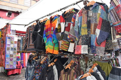 Multi colored umbrellas hanging for sale at market stall