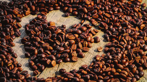 Close-up of heart shape roasted coffee beans on table