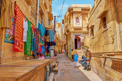 People walking on street amidst buildings in city