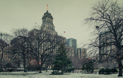 Low angle view of buildings against cloudy sky