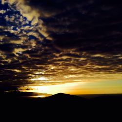 Scenic view of dramatic sky at sunset