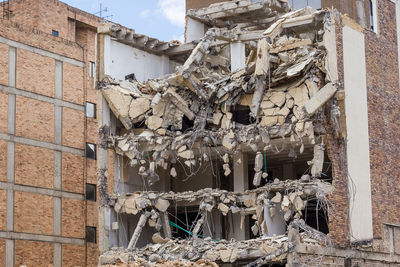 Low angle view of damaged building against sky