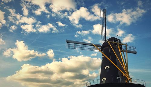 Low angle view of traditional windmill against sky