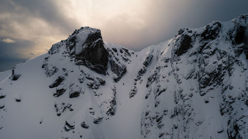 Scenic view of snow covered mountains against sky