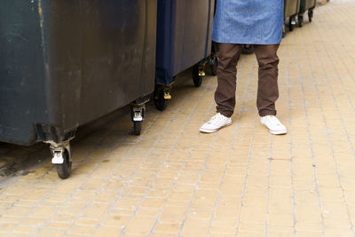 Low section of woman walking on footpath