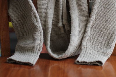 Low section of man wearing canvas shoes at home