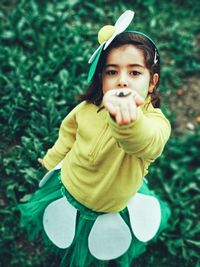 Close-up portrait of cute girl in costume standing on field