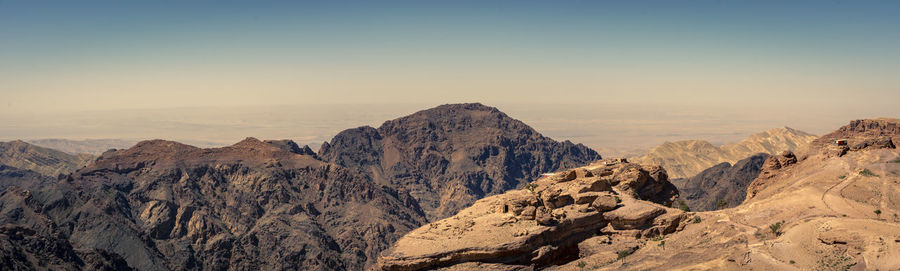 Panoramic view of rocky mountains against clear sky