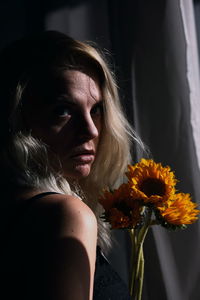 Close-up of young woman with bouquet