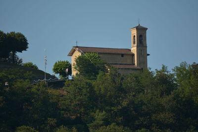 Trees and building against sky