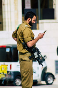 Side view of man holding camera