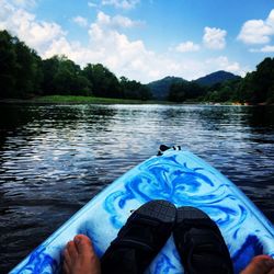 Low angle view of person rowing boat on lake