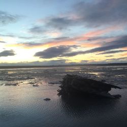 Scenic view of sea against cloudy sky