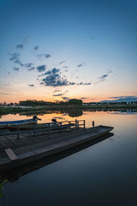 Boats in swimming pool against sky during sunset