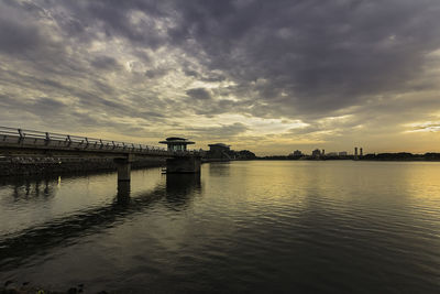 Bridge over river against sky during sunset