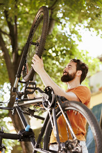 Low angle view of woman riding bicycle