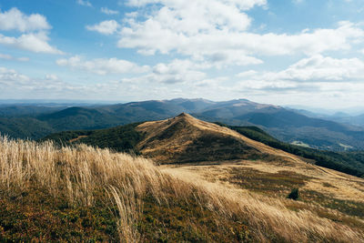 Scenic view of mountains against cloudy sky